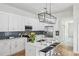 Modern kitchen with white cabinets, stainless steel appliances, and a breakfast bar at 726 Brookline Sw St, Atlanta, GA 30310