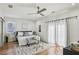 Bright main bedroom with hardwood floors, ceiling fan, and sitting area at 726 Brookline Sw St, Atlanta, GA 30310