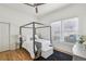 Comfortable main bedroom with a canopy bed, hardwood floors, and natural light at 726 Brookline Sw St, Atlanta, GA 30310