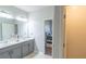 Large bathroom featuring double sinks and an entrance to the main bedroom at 8125 Berrywood Se Ct, Covington, GA 30014