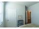 Bedroom featuring a storage cabinet, window, and door to another room at 8125 Berrywood Se Ct, Covington, GA 30014
