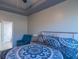 Brightly decorated main bedroom featuring tray ceilings and hardwood floors at 8125 Berrywood Se Ct, Covington, GA 30014