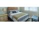 Bedroom with a large window and decorative bedside table and lamps at 8125 Berrywood Se Ct, Covington, GA 30014
