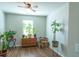 Bright bedroom with plants, hardwood floors and a ceiling fan at 8125 Berrywood Se Ct, Covington, GA 30014