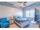 Well-lit main bedroom featuring tray ceilings, ceiling fan, and an oversized window at 8125 Berrywood Se Ct, Covington, GA 30014