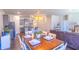 The dining room with modern lighting is open to the kitchen and living room at 8125 Berrywood Se Ct, Covington, GA 30014