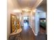 Hallway with decorative table, mirror, and view into the living room and bedroom at 8125 Berrywood Se Ct, Covington, GA 30014