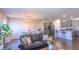 Open concept living room and kitchen with dark hardwood floors, granite countertops and stainless steel appliances at 8125 Berrywood Se Ct, Covington, GA 30014