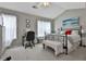 Bright bedroom with vaulted ceilings, a black metal bed frame, and a comfortable workspace at 2726 Northgate Nw Way, Acworth, GA 30101