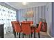 Formal dining room with blue striped walls, modern chandelier, and seating for six at 2726 Northgate Nw Way, Acworth, GA 30101