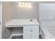 Bright bathroom featuring a modern vanity with white cabinets and a view to the window from the bathtub at 3060 White Oak Mews, Decatur, GA 30034