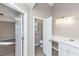 Bright bathroom with white vanity, new lighting, and an open view of the toilet and bedroom at 3060 White Oak Mews, Decatur, GA 30034