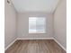 Bedroom featuring neutral walls, wood-look floors, and a window at 3060 White Oak Mews, Decatur, GA 30034