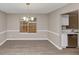 Dining area showcasing hardwood-style floors, neutral walls with white trim, and a view into the kitchen at 3060 White Oak Mews, Decatur, GA 30034
