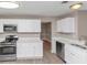 Kitchen with white cabinets, stainless steel appliances, and modern fixtures at 3060 White Oak Mews, Decatur, GA 30034