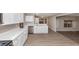 A bright kitchen featuring stainless steel appliances, white cabinets, and hardwood flooring at 3060 White Oak Mews, Decatur, GA 30034