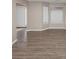 Living room with wood-look floors, windows with blinds, and neutral color walls and trim at 3060 White Oak Mews, Decatur, GA 30034