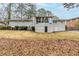 Back exterior featuring an enclosed sunroom, a brick facade and a large grassy yard at 3368 Windsor Castle Ct, Decatur, GA 30034