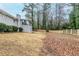 Back exterior featuring an enclosed sunroom, a brick facade and a large grassy yard at 3368 Windsor Castle Ct, Decatur, GA 30034