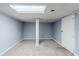 Finished basement with neutral carpet, painted gray walls, and tiled ceiling with recessed lighting at 3368 Windsor Castle Ct, Decatur, GA 30034