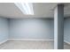 Basement featuring neutral carpeting, painted gray walls, a support beam, and tiled ceiling with recessed lighting at 3368 Windsor Castle Ct, Decatur, GA 30034