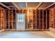 Unfinished basement featuring wooden frame walls, concrete floor, and a door at 3368 Windsor Castle Ct, Decatur, GA 30034