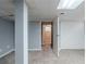 Basement featuring neutral carpeting, painted gray walls, a support beam, and a door leading to another room at 3368 Windsor Castle Ct, Decatur, GA 30034