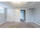 Finished basement with neutral carpet, painted gray walls, tiled ceiling, and a door leading to another room at 3368 Windsor Castle Ct, Decatur, GA 30034