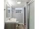 Bathroom with a glass-enclosed shower, vanity, mirror, and window at 3368 Windsor Castle Ct, Decatur, GA 30034