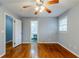 Bright bedroom with hardwood floors, ceiling fan, and view into bathroom at 3368 Windsor Castle Ct, Decatur, GA 30034
