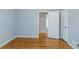 A bright bedroom with hardwood floors features an open door and a closet at 3368 Windsor Castle Ct, Decatur, GA 30034