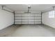 Spacious garage with white walls, concrete floor, window, and a white door at 3368 Windsor Castle Ct, Decatur, GA 30034