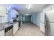 Renovated kitchen with stainless steel appliances and light grey walls connecting to living area at 3368 Windsor Castle Ct, Decatur, GA 30034