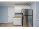 A kitchen area with stainless steel refrigerator, granite countertops, and white cabinets at 3368 Windsor Castle Ct, Decatur, GA 30034