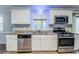 Updated kitchen with stainless steel appliances, granite countertops, and new fixtures at 3368 Windsor Castle Ct, Decatur, GA 30034