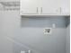Clean laundry room featuring overhead storage and natural light at 3368 Windsor Castle Ct, Decatur, GA 30034