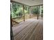 Spacious wooden back deck offers a relaxing outdoor living space with a view of the surrounding trees at 8033 White Stone Blvd, Douglasville, GA 30135