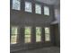 Bright room with soaring windows, ready for personalization to create a cozy living space at 8033 White Stone Blvd, Douglasville, GA 30135