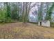 Large backyard with a storage shed and mature trees at 2024 Rosewood Rd, Decatur, GA 30032