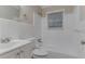 Full white bathroom featuring vanity, mirror, toilet, and shower with tub at 2024 Rosewood Rd, Decatur, GA 30032