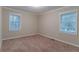 Bedroom featuring plush carpeting, neutral walls, and abundant natural light at 2024 Rosewood Rd, Decatur, GA 30032