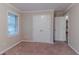 Spacious bedroom with carpeted floors, neutral walls, closet, and great natural light at 2024 Rosewood Rd, Decatur, GA 30032