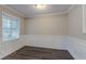 Dining room area featuring wood flooring, paneled walls, and natural light at 2024 Rosewood Rd, Decatur, GA 30032