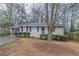 Single story home with brick facade, black shutters and mature tree in front yard at 2024 Rosewood Rd, Decatur, GA 30032