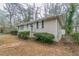 Side view of ranch style home showing painted brick, dark shutters, and fenced yard at 2024 Rosewood Rd, Decatur, GA 30032