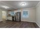 Bright kitchen featuring stainless steel appliances, white cabinets, and dark hardwood flooring at 2024 Rosewood Rd, Decatur, GA 30032