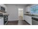 Kitchen showcasing stainless steel appliances, granite counters, and white cabinetry at 2024 Rosewood Rd, Decatur, GA 30032