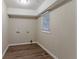 Empty laundry room featuring wood-look flooring, neutral walls, and hookups for a washer and dryer at 2024 Rosewood Rd, Decatur, GA 30032