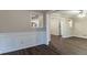 Open-concept living room featuring wood-look flooring, molding details, neutral wall color, and abundant natural light at 2024 Rosewood Rd, Decatur, GA 30032
