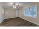 Light-filled living room featuring dark wood floors, ceiling fan, and view of front yard at 2024 Rosewood Rd, Decatur, GA 30032
